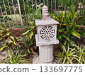 traditional old stone lantern in india garden. 133697775