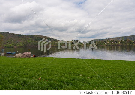 Fishing tents and rods on riverbank at Nova Zivohost, Czech Republic. 133698517