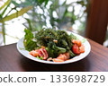 Seaweed salmon salad Cook filling poke with sauce. Vegetables, seaweed and fish. Slow motion 133698729