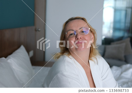 Home, kiss and portrait of woman on bed for relaxing, resting and comfortable in bedroom in morning. Apartment, blanket and person with wink, pout and wake up for health, wellness and weekend Home, kiss and portrait of woman on bed for relaxing, resting and comfortable in bedroom in morning. Apartment, blanket and person with wink, pout and wake up for health, wellness and weekend 133698733