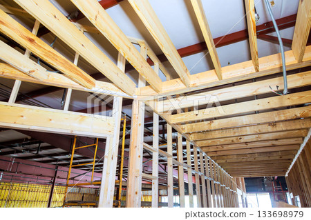 Construction site wooden framing rafters in progress during renovation Construction site wooden framing rafters in progress during renovation 133698979