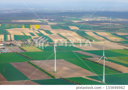 Wind turbines stand out in vast patchwork of fields in rural landscape Vienna, Austria Wind turbines stand out in vast patchwork of fields in rural landscape Vienna, Austria 133698982