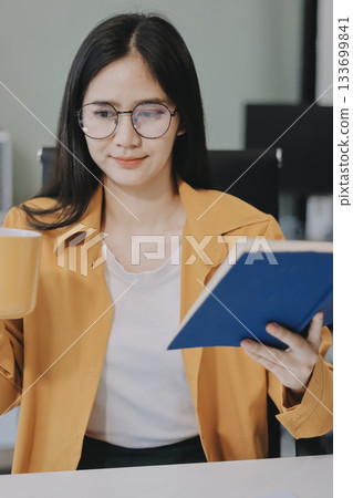 Business woman using calculator for do math finance on wooden desk in office and business working background, tax, accounting, statistics and analytic research concept. 133699841