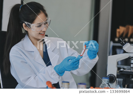 Portrait, science and happy woman on laptop in lab to research chemistry, test or innovation. Microscope, scientist and face of medical doctor in goggles for microbiology, healthcare or pharma study Portrait, science and happy woman on laptop in lab to research chemistry, test or innovation. Microscope, scientist and face of medical doctor in goggles for microbiology, healthcare or pharma study 133699864