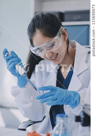 Portrait, science and happy woman on laptop in lab to research chemistry, test or innovation. Microscope, scientist and face of medical doctor in goggles for microbiology, healthcare or pharma study Portrait, science and happy woman on laptop in lab to research chemistry, test or innovation. Microscope, scientist and face of medical doctor in goggles for microbiology, healthcare or pharma study 133699873