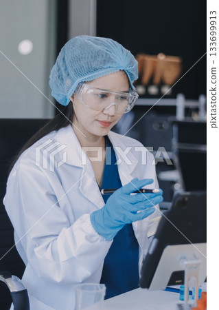 Portrait, science and happy woman on laptop in lab to research chemistry, test or innovation. Microscope, scientist and face of medical doctor in goggles for microbiology, healthcare or pharma study 133699913
