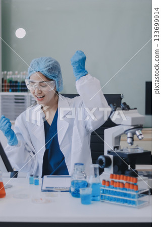 Portrait, science and happy woman on laptop in lab to research chemistry, test or innovation. Microscope, scientist and face of medical doctor in goggles for microbiology, healthcare or pharma study 133699914