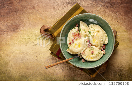 Dumplings, with fried prosciutto, a traditional dish of Polish cuisine, dumplings, top view, close-up, without people, Dumplings, with fried prosciutto, a traditional dish of Polish cuisine, dumplings, top view, close-up, without people, 133700198