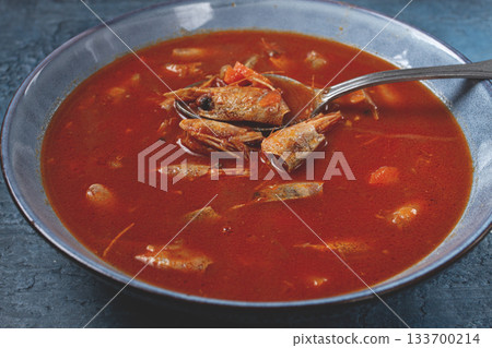 French shrimp bisque soup, in a plate, on a blue background, close-up, no people, French shrimp bisque soup, in a plate, on a blue background, close-up, no people, 133700214