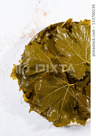 canned grape leaves, for cooking dolma, on a plate, canned grape leaves, for cooking dolma, on a plate, 133700238