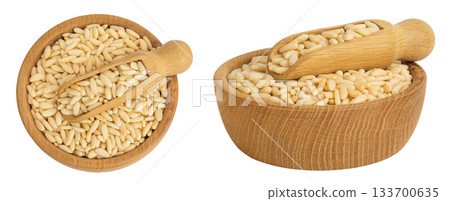 Shelled European pine nuts in wooden bowl and scoop isolated on white background. Top view. Flat lay Shelled European pine nuts in wooden bowl and scoop isolated on white background. Top view. Flat lay 133700635