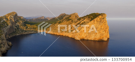 Golden sunset over the cliffs of Cap de Formentor, Mallorca, Spain. Breathtaking Mediterranean landscape with sun rays over the rocky coast, captured in stunning high resolution. Golden sunset over the cliffs of Cap de Formentor, Mallorca, Spain. Breathtaking Mediterranean landscape with sun rays over the rocky coast, captured in stunning high resolution. 133700954