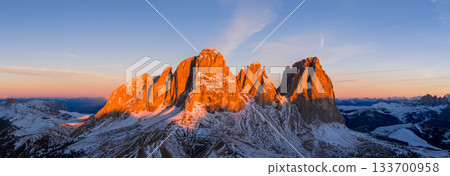 Panoramic view of Dolomite mountain peaks in beautiful morning light. Early winter scene with snow-covered summits, captured in high resolution. perfect for large fine art prints. Panoramic view of Dolomite mountain peaks in beautiful morning light. Early winter scene with snow-covered summits, captured in high resolution. perfect for large fine art prints. 133700958