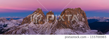 Panoramic view of Dolomite mountain peaks in beautiful morning light. Early winter scene with snow-covered summits, captured in high resolution, perfect for large fine art prints. Panoramic view of Dolomite mountain peaks in beautiful morning light. Early winter scene with snow-covered summits, captured in high resolution, perfect for large fine art prints. 133700965