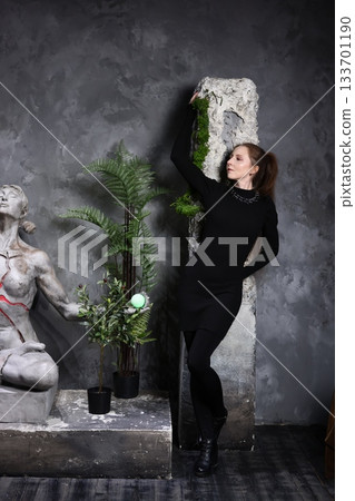 Museum expert carefully examines ancient sculpture carefully 133701190