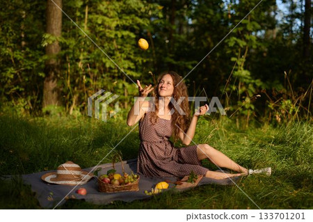 Cheerful woman in casual attire enjoying sunny picnic moment Cheerful woman in casual attire enjoying sunny picnic moment 133701201