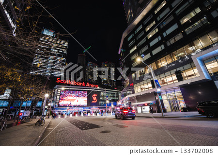Toronto, Canada, 20 October 2025: Night view of Scotiabank Arena with illuminated screens, visitors, and surrounding modern high-rise buildings 133702008