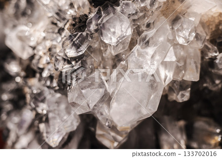 Bright quartz crystal cluster with intergrown transparent points and detailed natural mineral texture Bright quartz crystal cluster with intergrown transparent points and detailed natural mineral texture 133702016