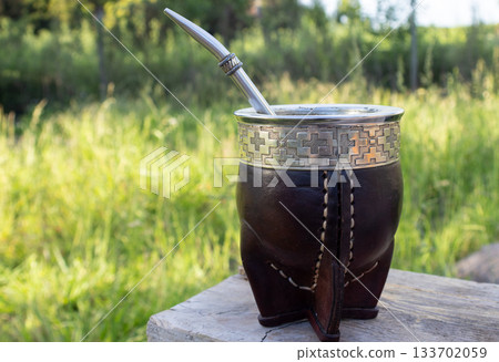 Yerba mate experience in a traditional leather gourd, enjoying the rich culture and daily ritual of this south american infusion in an outdoor setting 133702059