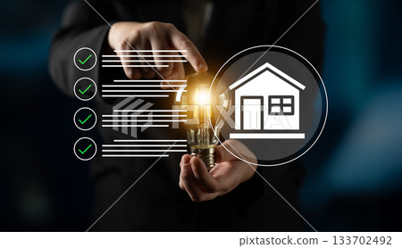 Businessman Holding Light Bulb Symbolizing Innovative Ideas for Smart Home Solutions with Checklist Concept in Background Gantry Businessman Holding Light Bulb Symbolizing Innovative Ideas for Smart Home Solutions with Checklist Concept in Background Gantry 133702492