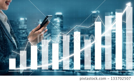 Businesswoman Holding Smartphone While Analyzing Data Graphs and Financial Growth Trends in a Modern Urban Environment at Night Copula Businesswoman Holding Smartphone While Analyzing Data Graphs and Financial Growth Trends in a Modern Urban Environment at Night Copula 133702507