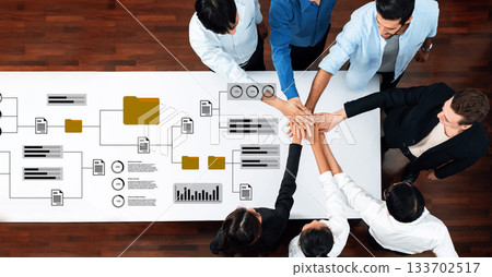 Collaborative Team Meeting with High-Five Gesture over Business Charts and Graphs in Modern Office Setting Gantry Collaborative Team Meeting with High-Five Gesture over Business Charts and Graphs in Modern Office Setting Gantry 133702517