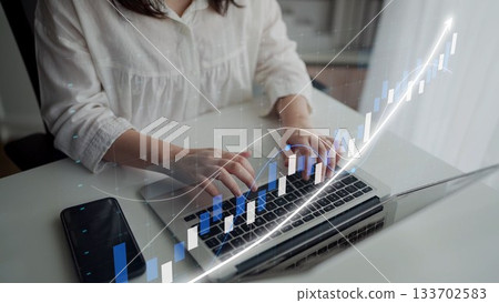 Woman in white blouse working on laptop with financial graph overlay, analyzing data for business growth and investment strategy development in modern workspace Copula Woman in white blouse working on laptop with financial graph overlay, analyzing data for business growth and investment strategy development in modern workspace Copula 133702583