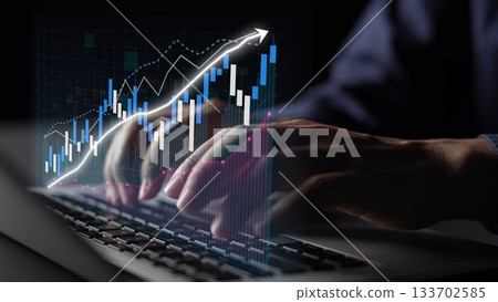 Hands Typing on Laptop with Dynamic Financial Chart Displayed on Screen, Representing Data Analysis and Stock Market Trends Copula 133702585