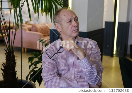 Lonely retirement. Headshot of sad upset elderly male feel desperate tired having mental health problems. Depressed old man pensioner lost in bad thoughts grieving alone suffering of senile dementia Lonely retirement. Headshot of sad upset elderly male feel desperate tired having mental health problems. Depressed old man pensioner lost in bad thoughts grieving alone suffering of senile dementia 133702688