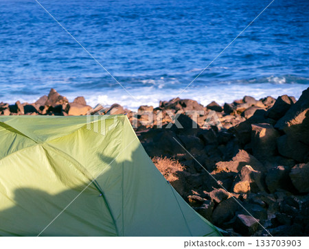 A tent for travelling and camping on the ocean coast background. 133703903
