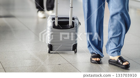 People walk with suitcases, travel bags at the airport. 133703910
