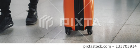 A suitcase in a red color closeup, a luggage at the airport. 133703914