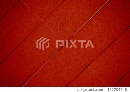 Red plastic texture background with diagonal parallel lines 133704048