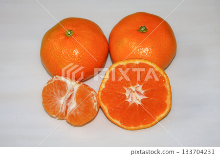 fresh tangerines on a white wooden background. 133704231