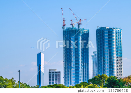 View of Tokyo cityscape in Japan, including airplanes, the Toyonaka district and tower apartments under construction View of Tokyo cityscape in Japan, including airplanes, the Toyonaka district and tower apartments under construction 133706428