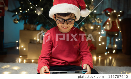 Boy on the Carpet playing with his Chrismas present 133707440