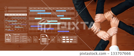 Collaborative Teamwork Planning and Organization with Gantt Chart and Task List Displayed on a Wooden Table Surface Gantry Collaborative Teamwork Planning and Organization with Gantt Chart and Task List Displayed on a Wooden Table Surface Gantry 133707666