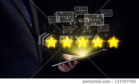 Businessman Holding Tablet with Five Star Reviews and Chat Bubbles Representing Customer Satisfaction and Digital Feedback. Qubit Businessman Holding Tablet with Five Star Reviews and Chat Bubbles Representing Customer Satisfaction and Digital Feedback. Qubit 133707760