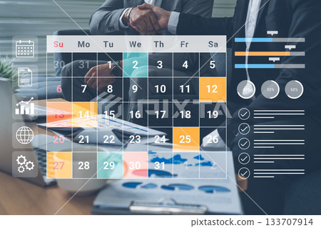 Business Partnership Meeting with Calendar Planning and Data Analysis on Desk featuring Charts, Graphs, and Professional Documents Gantry 133707914