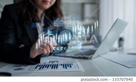 Business professional analyzing digital financial charts with modern technology in a bright office setting, showcasing trends and data visualization Scalp Business professional analyzing digital financial charts with modern technology in a bright office setting, showcasing trends and data visualization Scalp 133707940