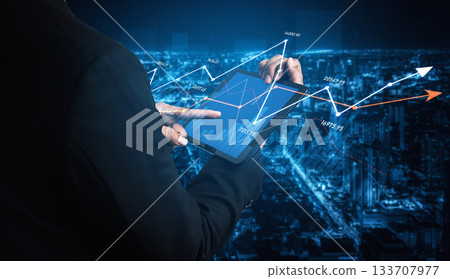 Business Professional Analyzing Data Trends on Tablet Device at Night with Cityscape Background and Graph Overlays for Financial Insights Scalp Business Professional Analyzing Data Trends on Tablet Device at Night with Cityscape Background and Graph Overlays for Financial Insights Scalp 133707977
