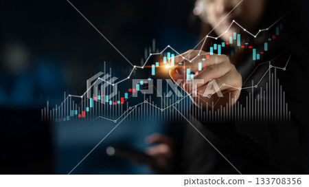 Business professional analyzing financial data on digital screen with glowing charts and graphs representing market trends and analysis in a modern office setting Scalp 133708356