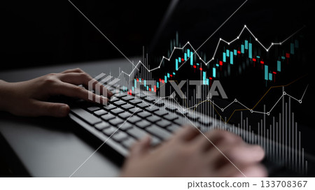 Hands on keyboard analyzing stock market trends with financial graphs on screen, symbolizing investment and trading strategies in digital finance Scalp 133708367