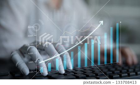 Innovative Robotics Concept Shows Mechanical Hand Interacting with Data Visualization and Growth Charts in Modern Workspace Scalp 133708413