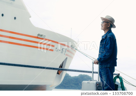Portrait of a senior man enjoying a trip while looking at the ship 133708700