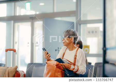 Senior woman waiting to depart at the ferry terminal 133708747