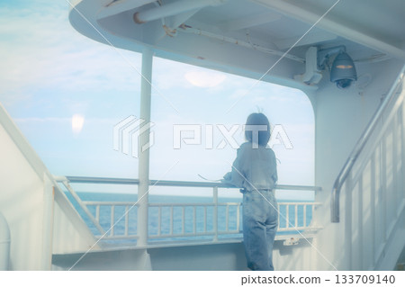 Travel scene of a woman in her twenties feeling the sea breeze on the deck of a ferry Travel scene of a woman in her twenties feeling the sea breeze on the deck of a ferry 133709140