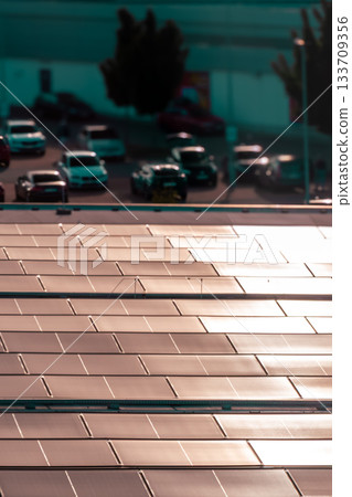 Solar Panels on Rooftop with Parking Lot and Urban Background Solar Panels on Rooftop with Parking Lot and Urban Background 133709356