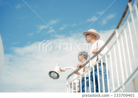 Travel scene of a senior couple looking at the scenery on the ferry deck 133709401