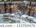 Cascading stone waterfall feature with flowing water 133709470